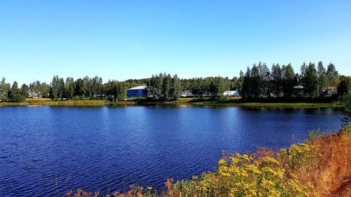 Scenic view of lake against clear blue sky