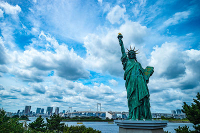 Statue of liberty against cloudy sky