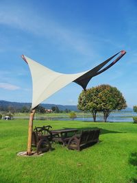 Traditional windmill on field against sky