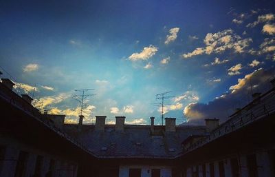 Low angle view of building against cloudy sky