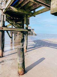 Tilt image of pier over sea against sky