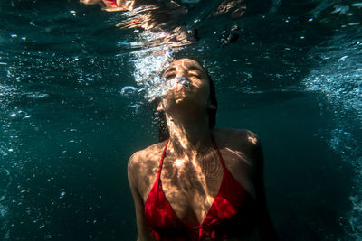 Woman swimming in sea