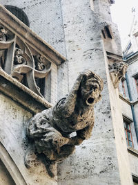 Low angle view of statue against old building