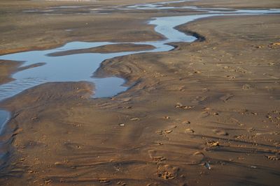 High angle view of wet sand on beach