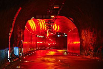 Illuminated tunnel at night