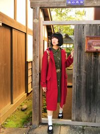 Full length of woman standing by entrance