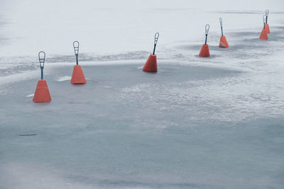 Red lanterns hanging over frozen water