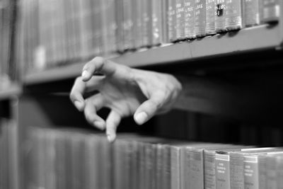 Horror themed hand sticking out of library bookshelf