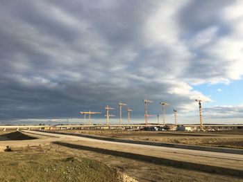 Railroad tracks on field against sky