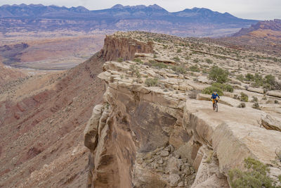 High angle view of man cycling on cliff