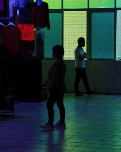 Rear view of people walking in corridor