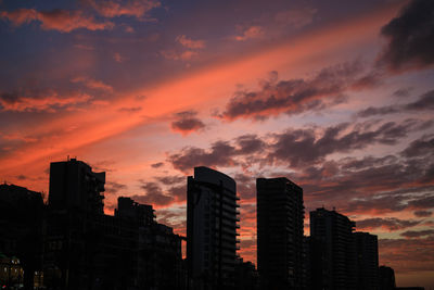 Low angle view of buildings against sky during sunset