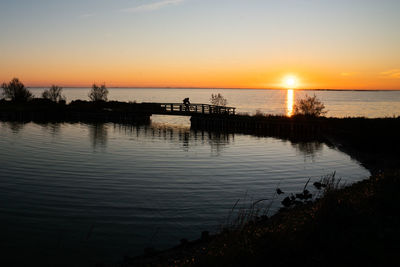 Scenic view of lake against sky during sunset