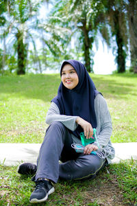 Young woman sitting on field