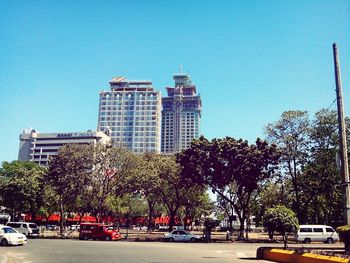 View of city street against blue sky