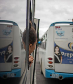 Close-up of woman in train against sky