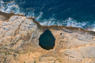 High angle view of rock formation on sea shore