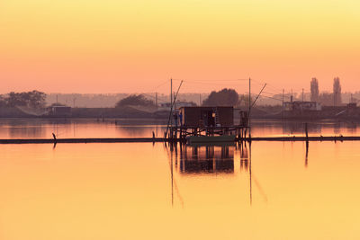 Scenic view of lake against sky during sunset