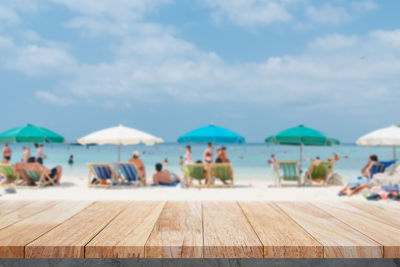 People on beach against sky