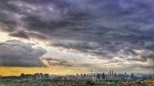View of cityscape against dramatic sky