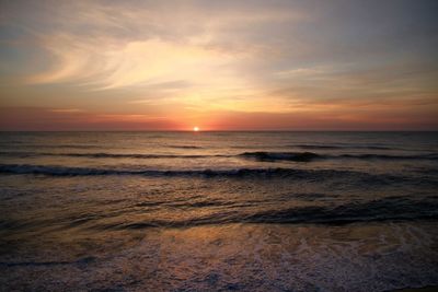 Scenic view of beach at sunset