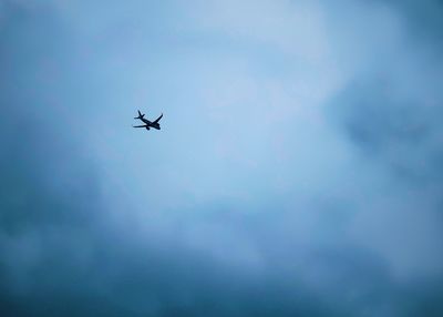 Low angle view of airplane flying in sky