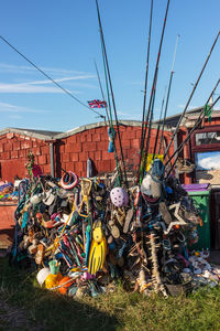 Stack of multi colored umbrellas hanging against built structure