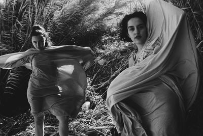 Portrait of young women standing in forest