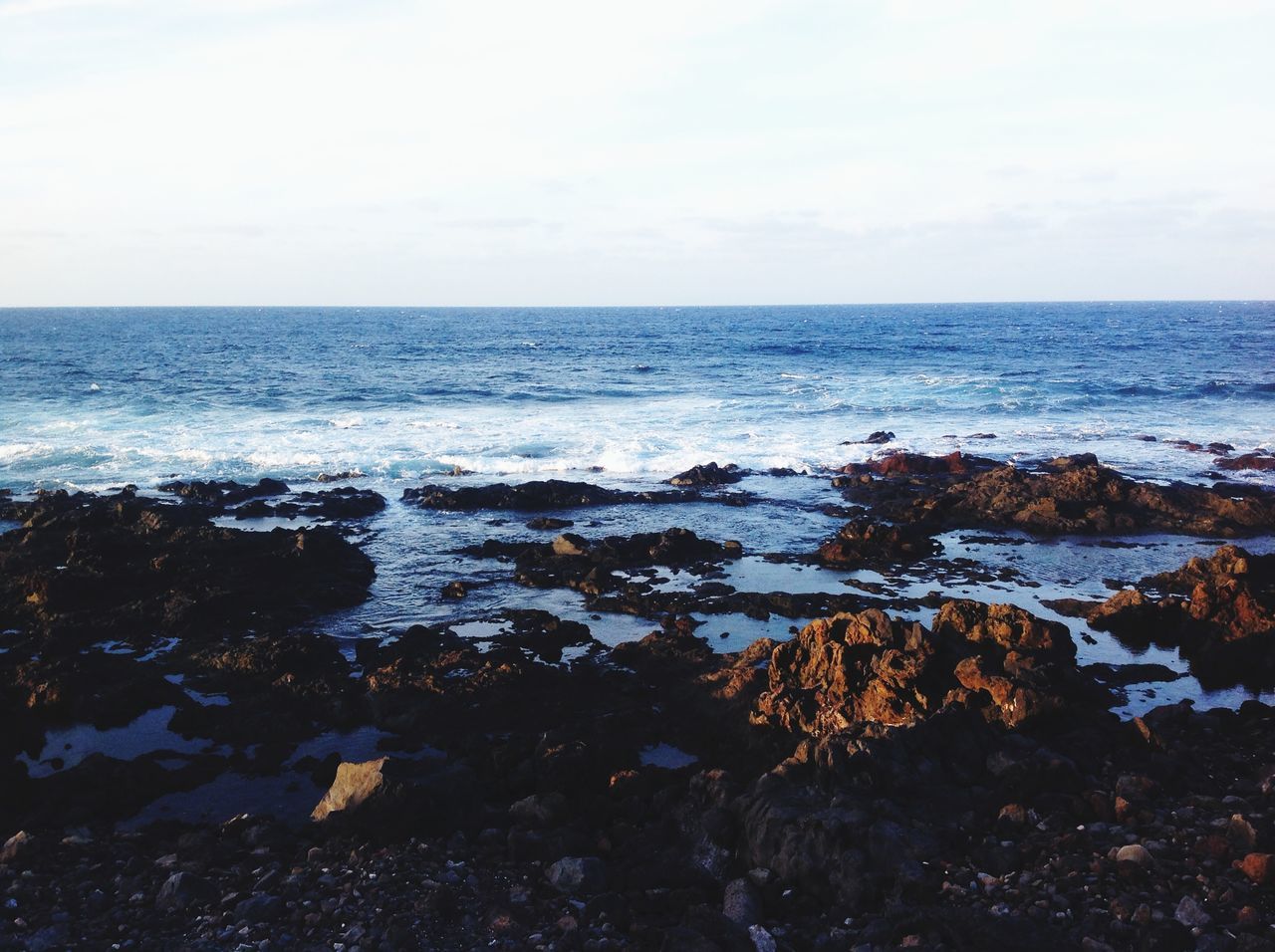 horizon over water, sea, water, scenics, tranquil scene, beauty in nature, tranquility, beach, sky, nature, shore, wave, idyllic, rock - object, clear sky, seascape, remote, surf, outdoors, copy space