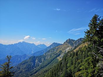 Scenic view of mountains against blue sky