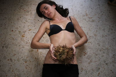 Portrait of woman standing against wall