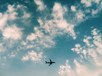 Low angle view of airplane flying in sky