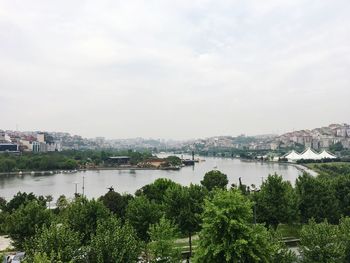 Panoramic view of city and river against sky