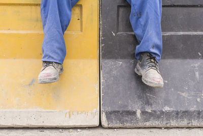 Low section of man working on concrete floor