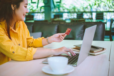 Young woman using laptop at table