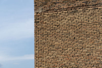 Low angle view of brick wall against clear sky