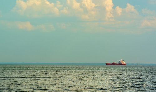 Boat sailing in sea against sky