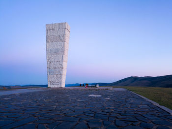 Built structure on land against clear blue sky