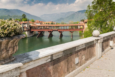 View of bridge over river against cloudy sky