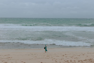 People on beach against sky