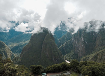 Panoramic view of trees and mountains against sky