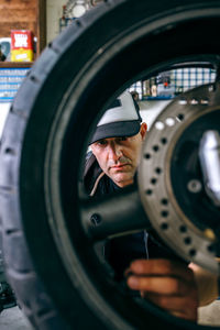 Man working on motorcycle in repair shop