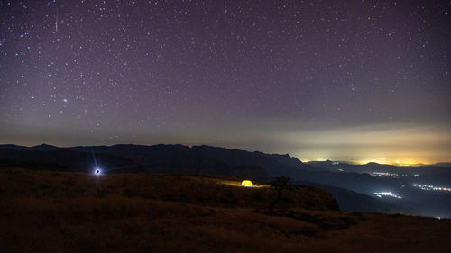 Scenic view of landscape against sky at night