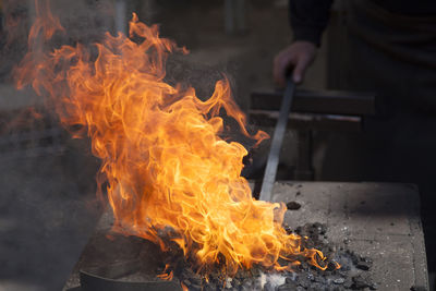 Blacksmith molding sword in fire
