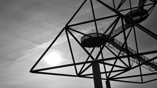 Low angle view of silhouette tower against sky