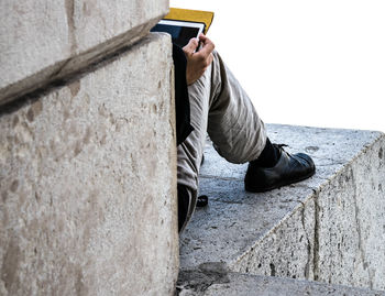 Low section of man sitting on floor