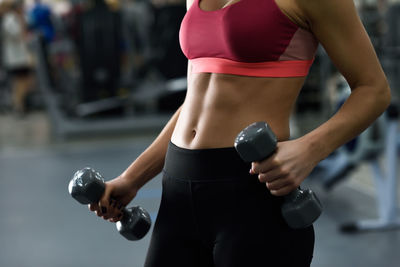 Midsection of woman exercising in gym