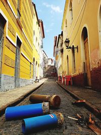 Empty alley amidst buildings in city