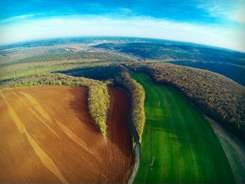 Scenic view of agricultural field against sky