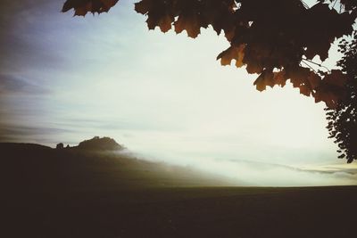 Scenic view of landscape against cloudy sky